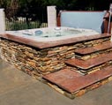hot tubs for sale with stone surronding picture